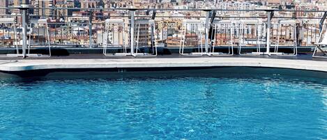 A swimming pool with a cityscape view in the background.