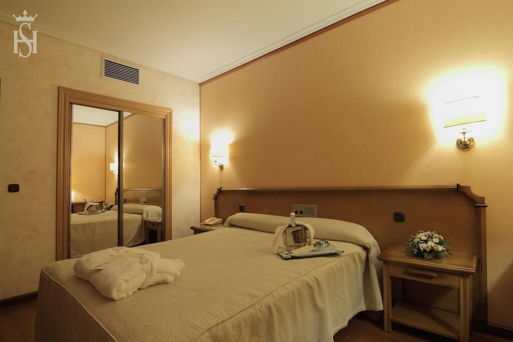 Minibar, escritorio, cortinas opacas y tabla de planchar con plancha