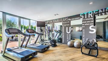 A modern gym with treadmills, weight machines, and exercise balls.