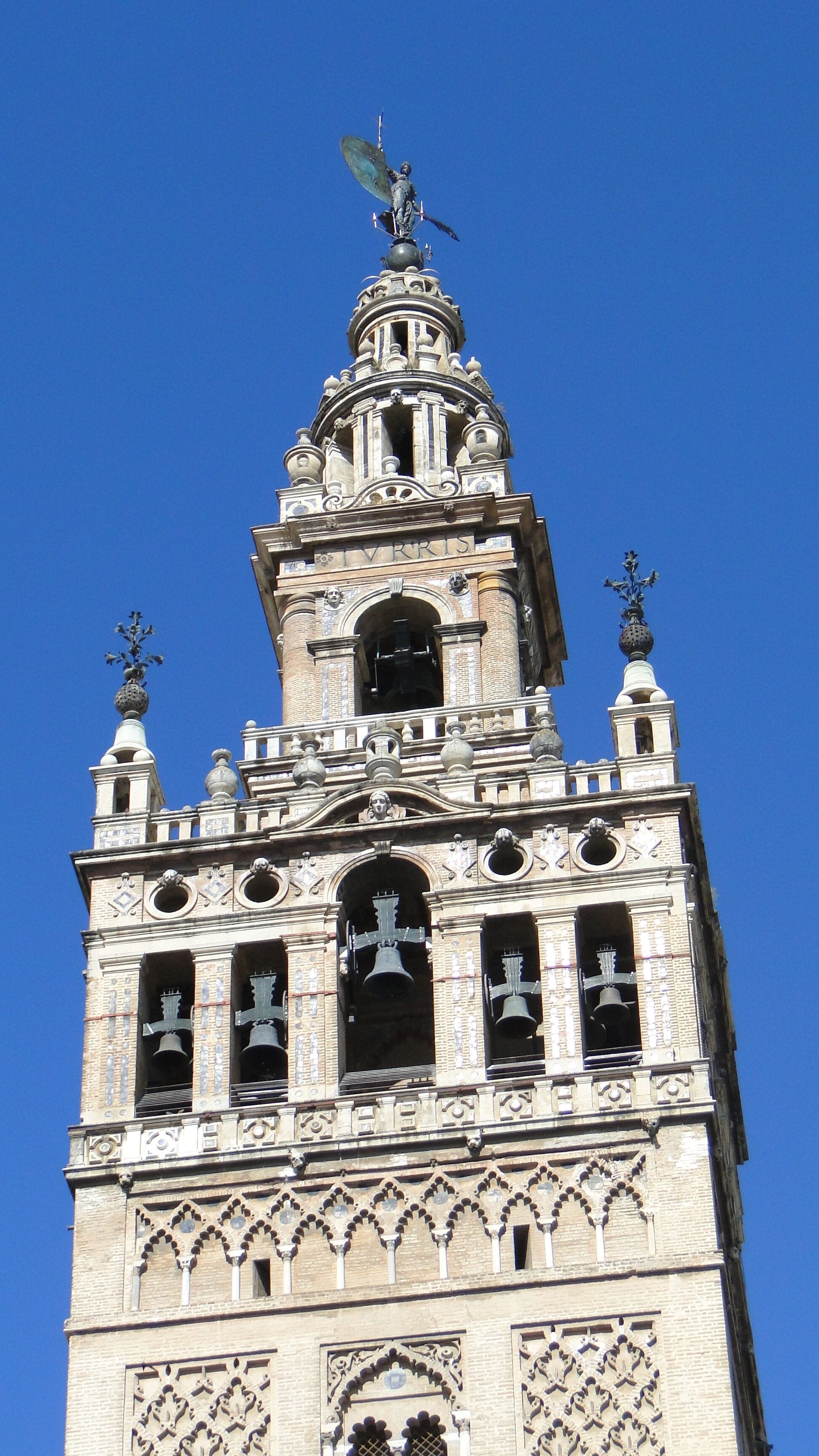 A historic tower with intricate architectural details, including multiple bell towers and ornate decorations.