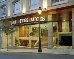 L’entrée d’un hôtel, avec une enseigne indiquant « HÔTEL TRES LUCES ».
