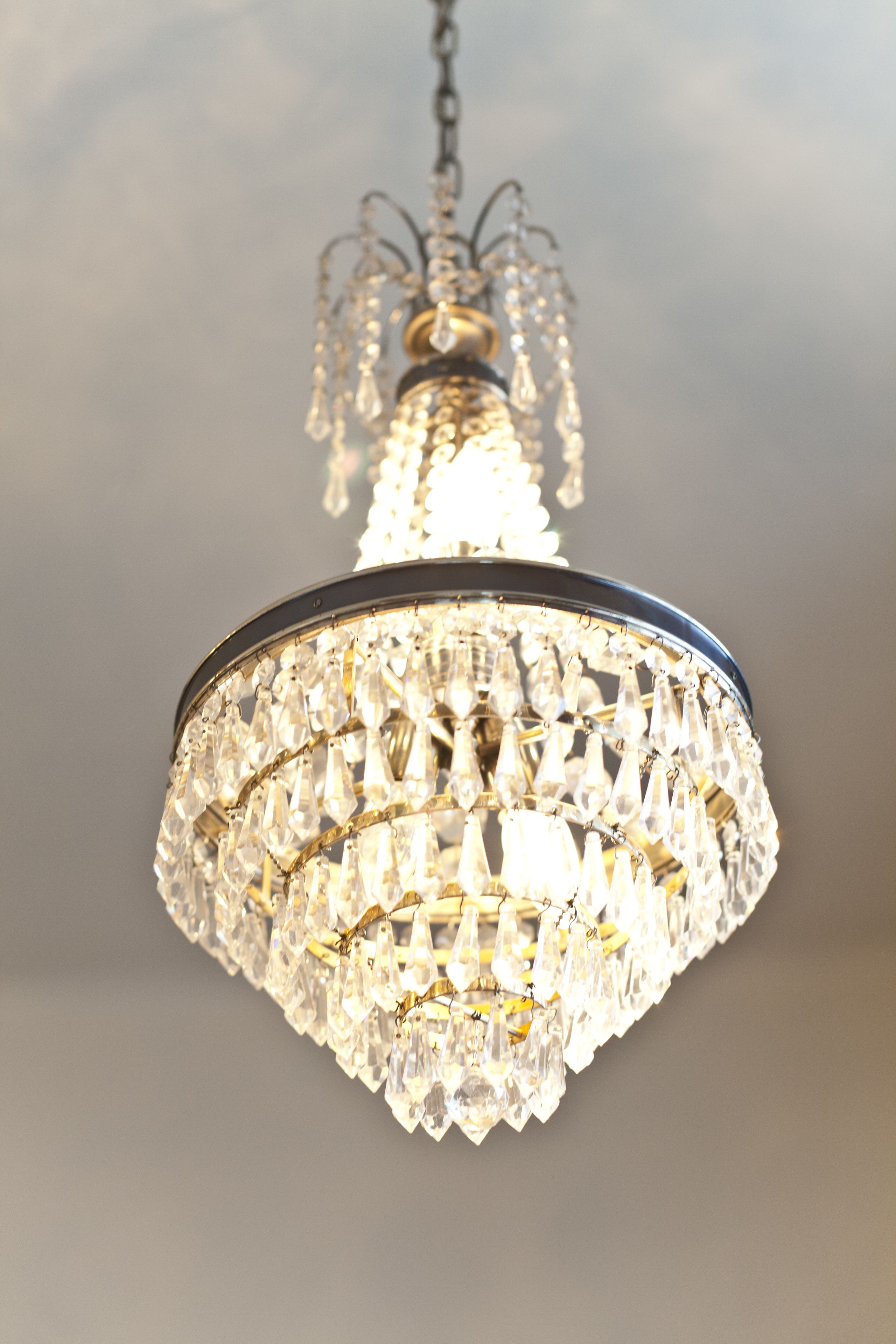 A chandelier with multiple crystal elements and a metallic frame.