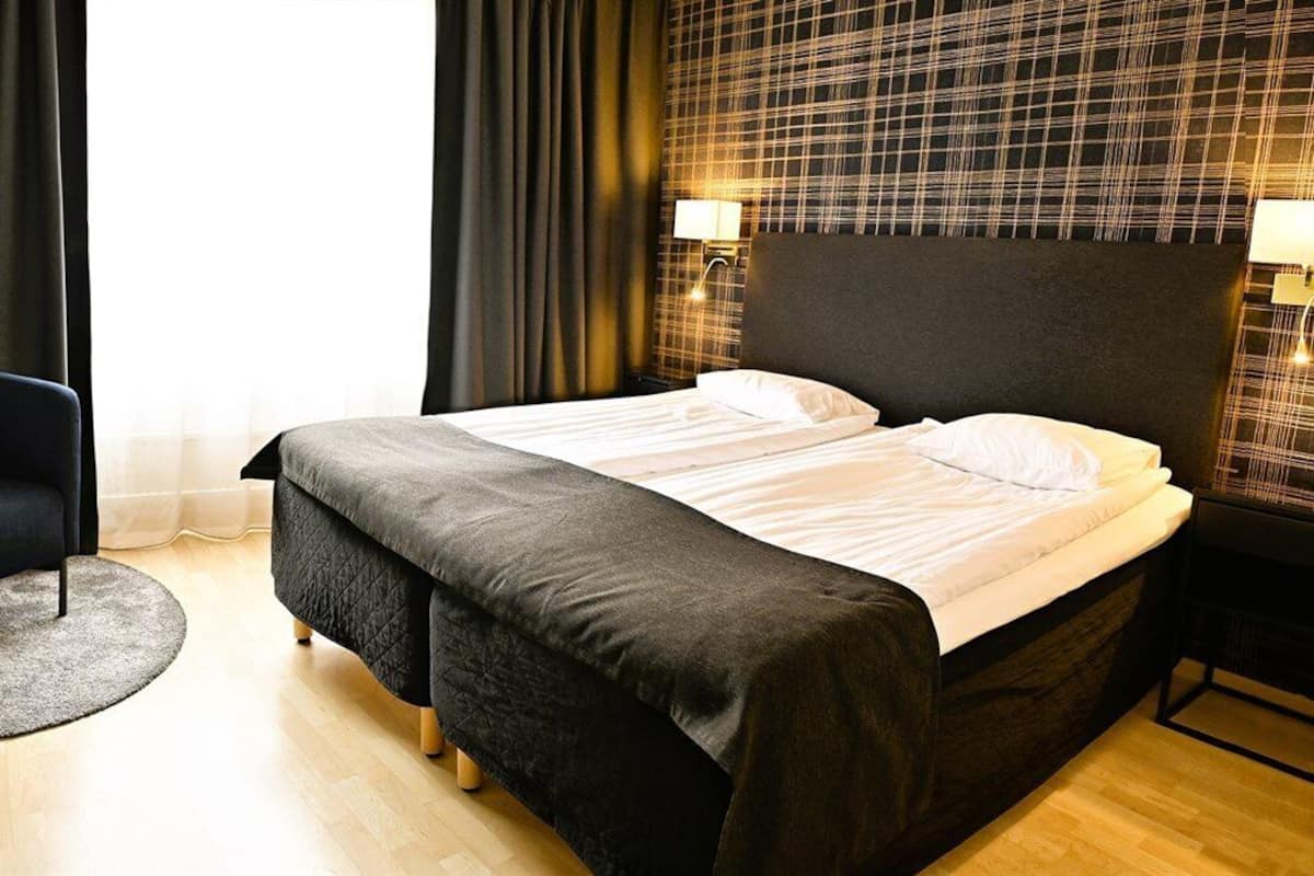 Ropa de cama hipoalergénica y caja de seguridad en la habitación