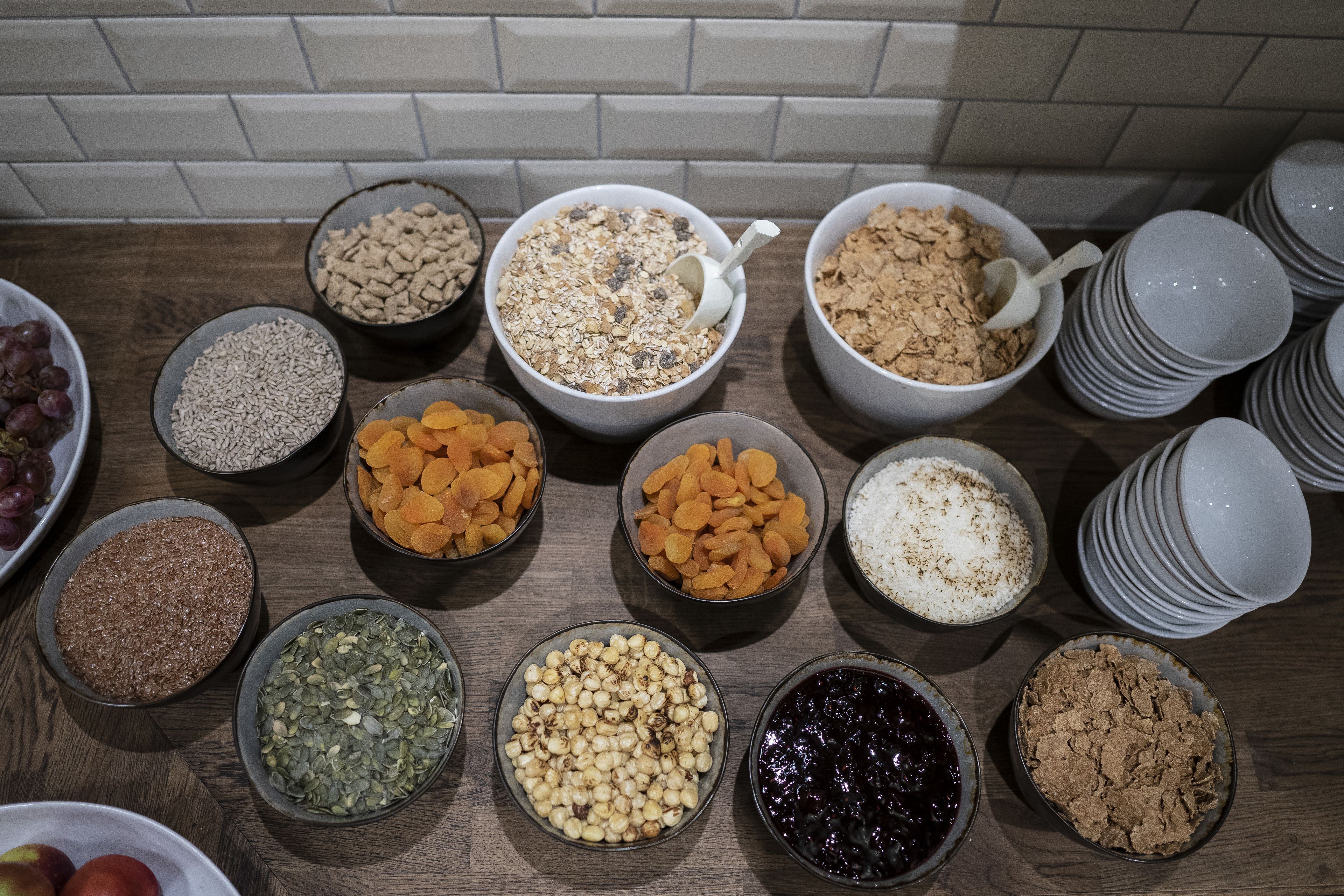 A variety of food items in bowls on a wooden table.