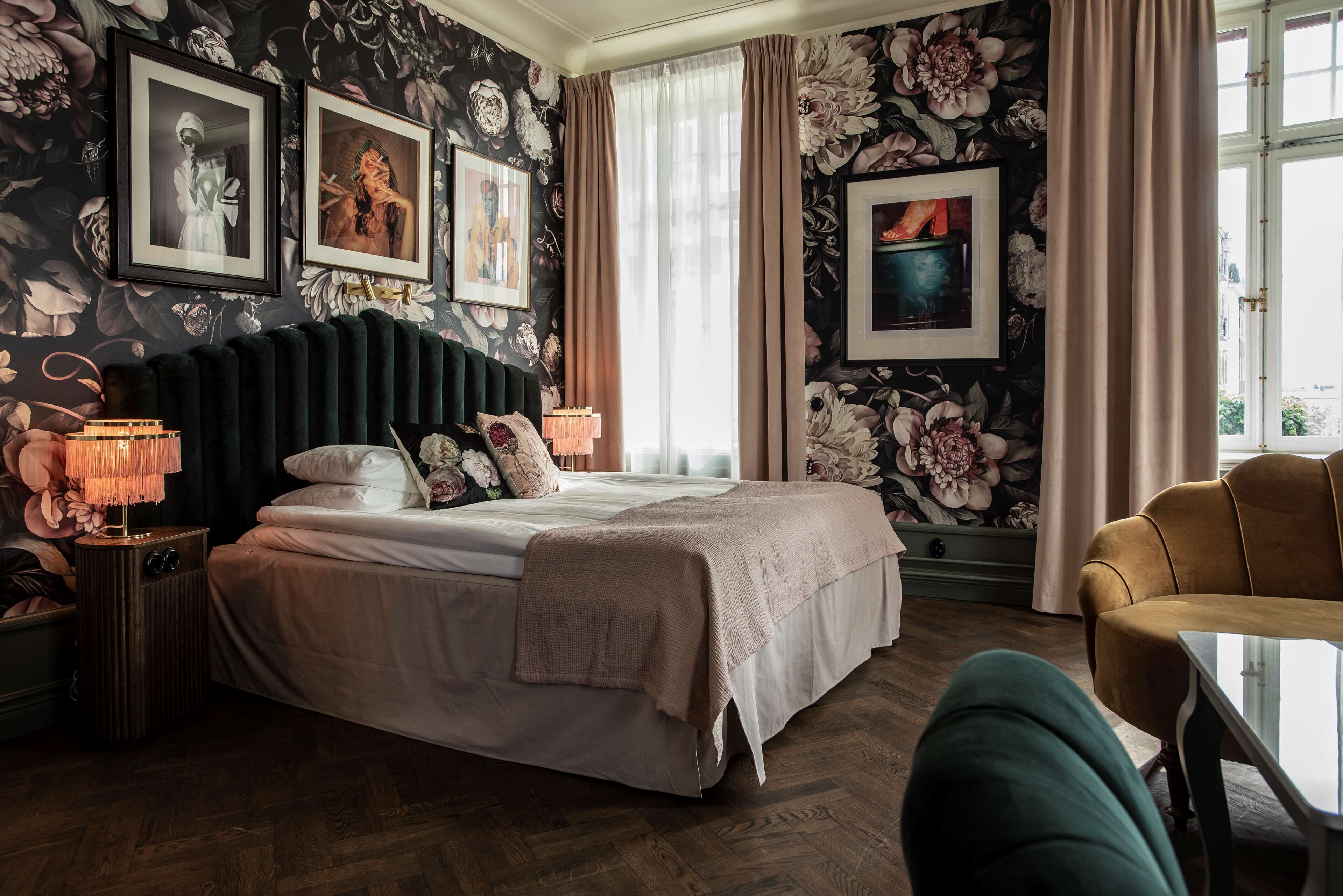 Une chambre à coucher avec un grand lit, une table de chevet, une lampe et une chaise.