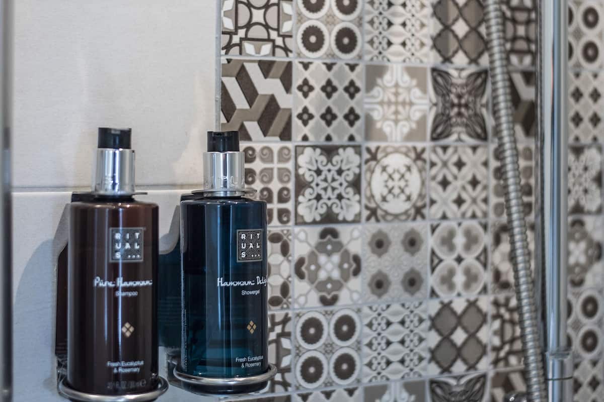 shower, designer toiletries, hair dryer, towels