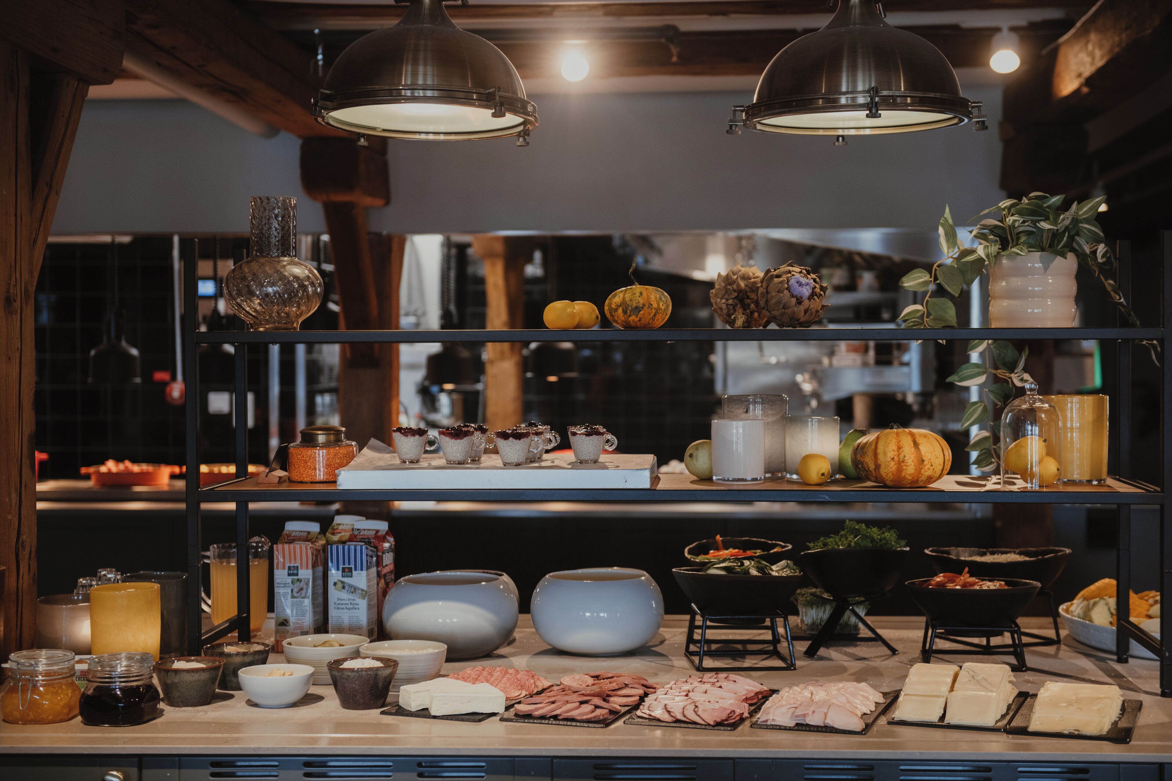 A buffet setup with various food items and beverages on display.