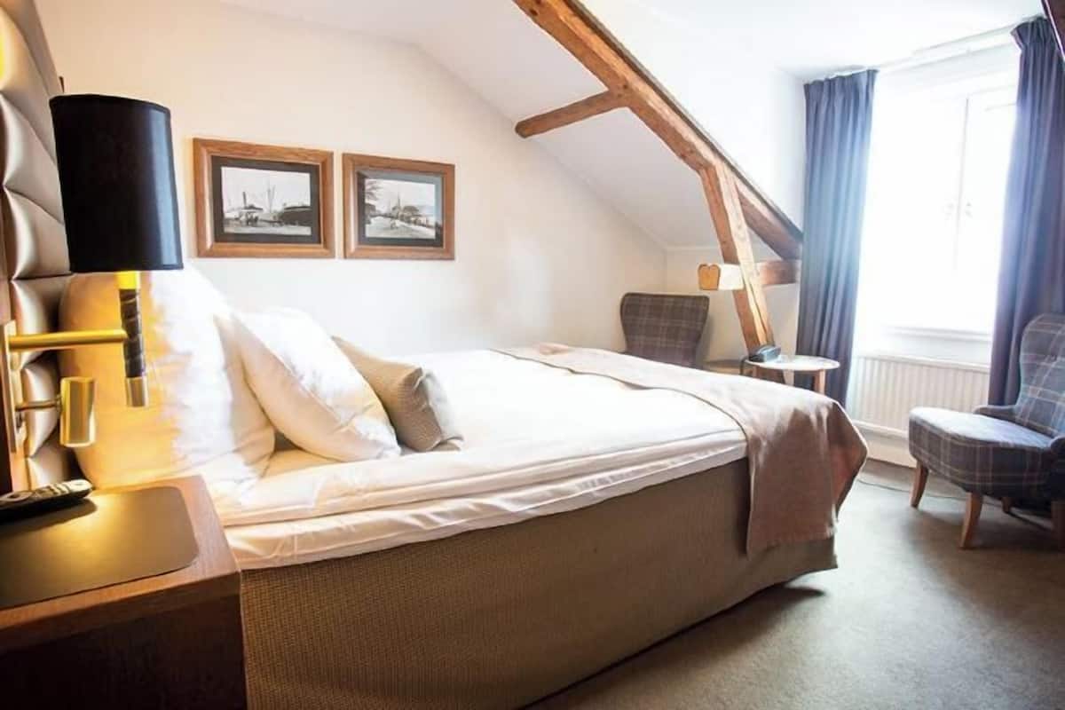 Desk, laptop workspace, iron/ironing board, bed sheets