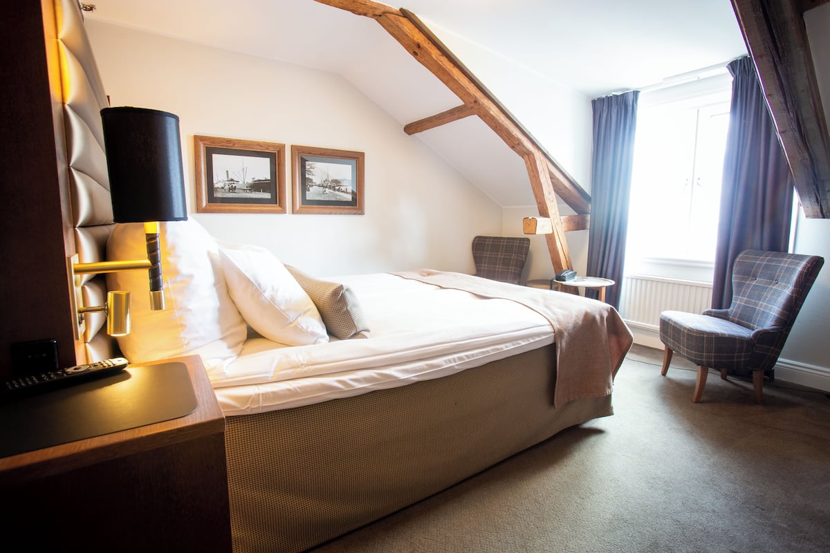 Desk, laptop workspace, iron/ironing board, bed sheets