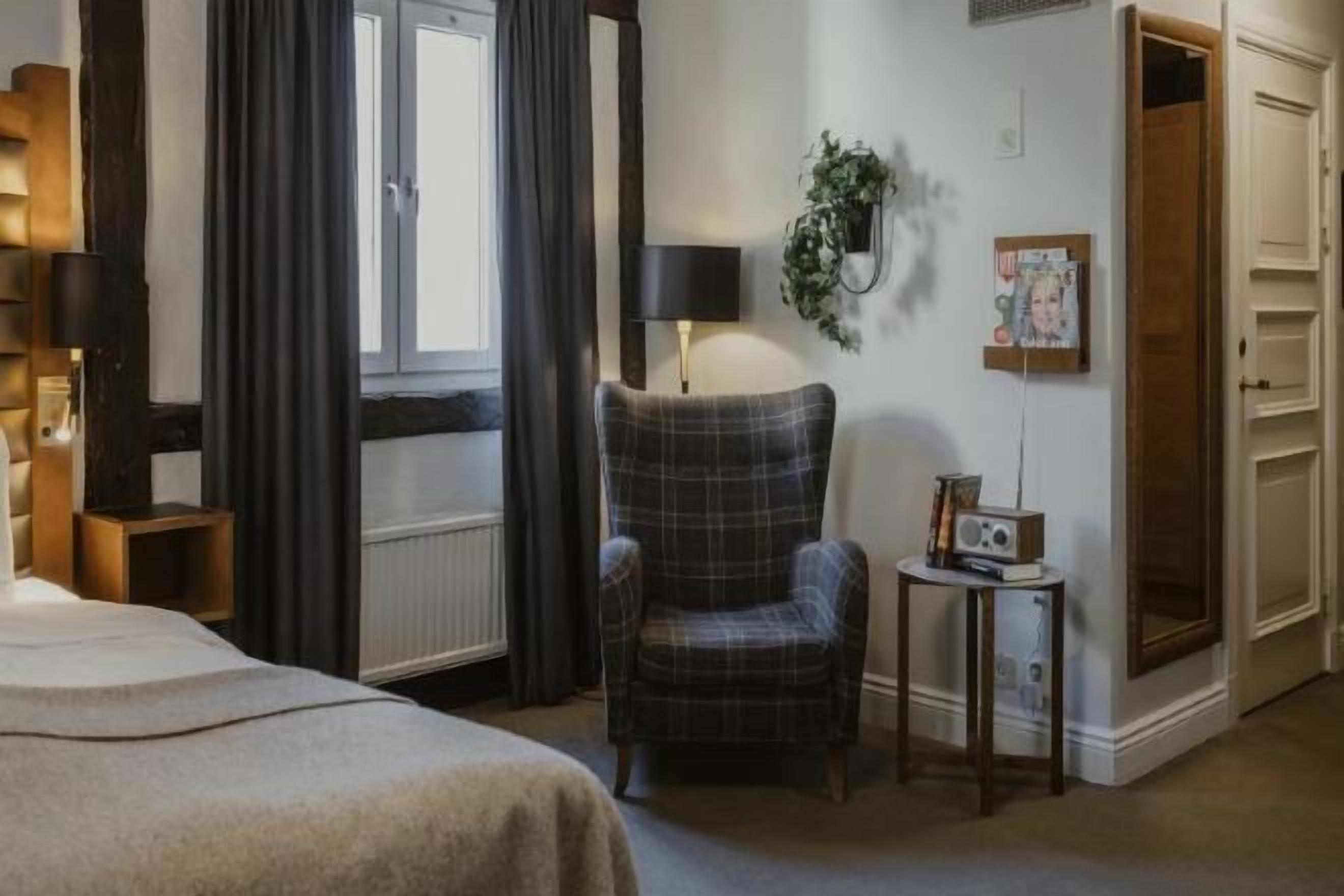 Desk, laptop workspace, iron/ironing board, bed sheets