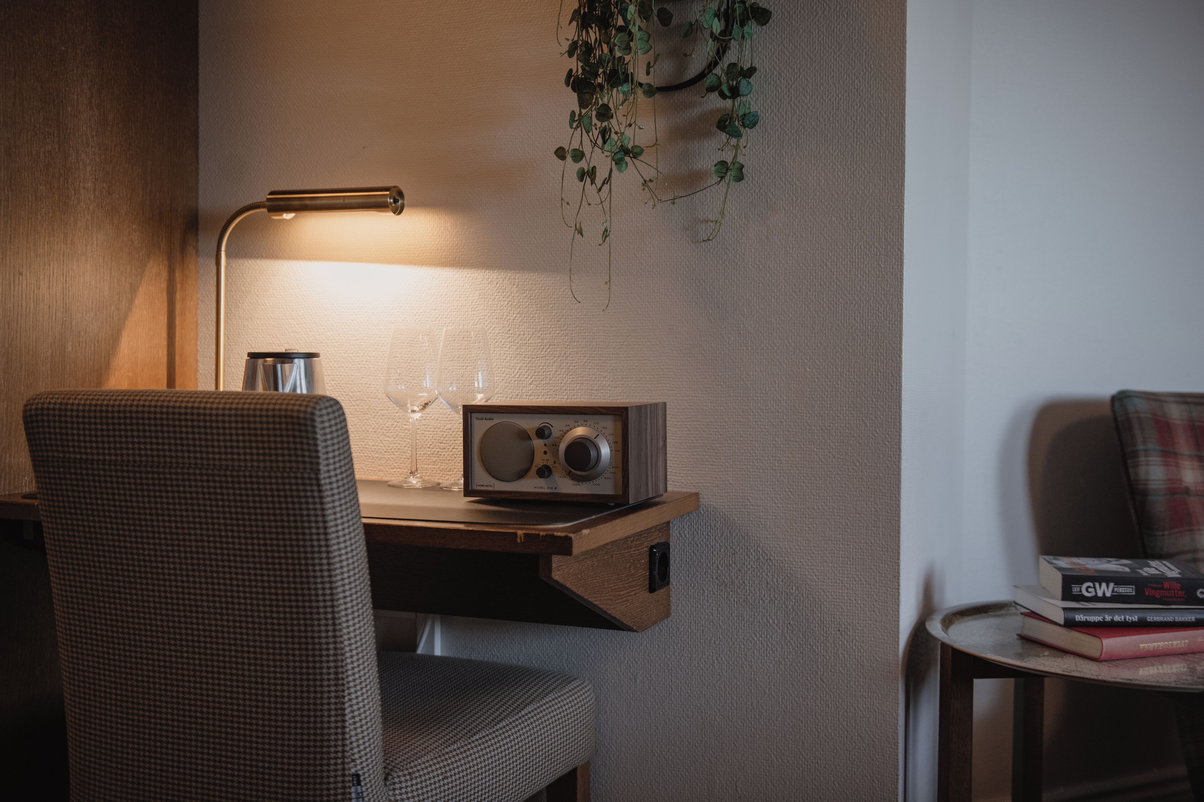 A cozy workspace with a desk, chair, and a radio.