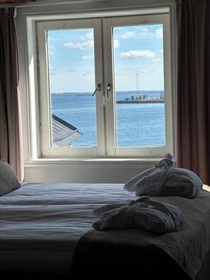 Desk, laptop workspace, iron/ironing board, bed sheets