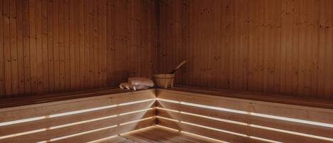 A sauna with wooden benches and a central bench.