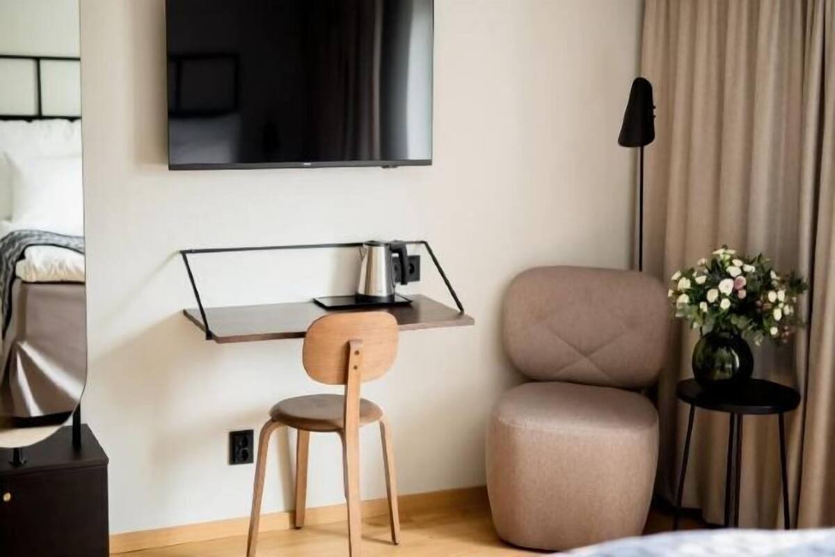 Desk, laptop workspace, iron/ironing board, bed sheets