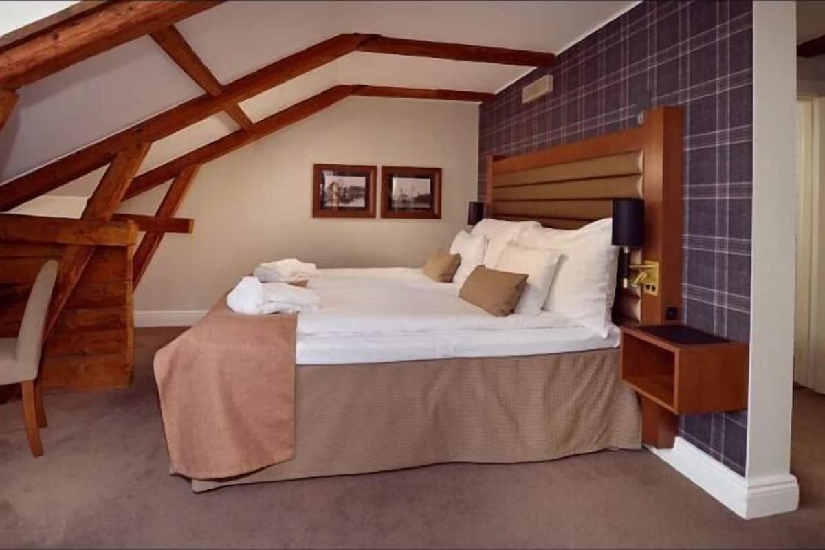 Desk, laptop workspace, iron/ironing board, bed sheets