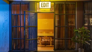 A modern interior with a prominent 'EDIT' sign, a glass door entrance, and a potted plant. - Best Western Plus Hotel Noble House (Malmö)