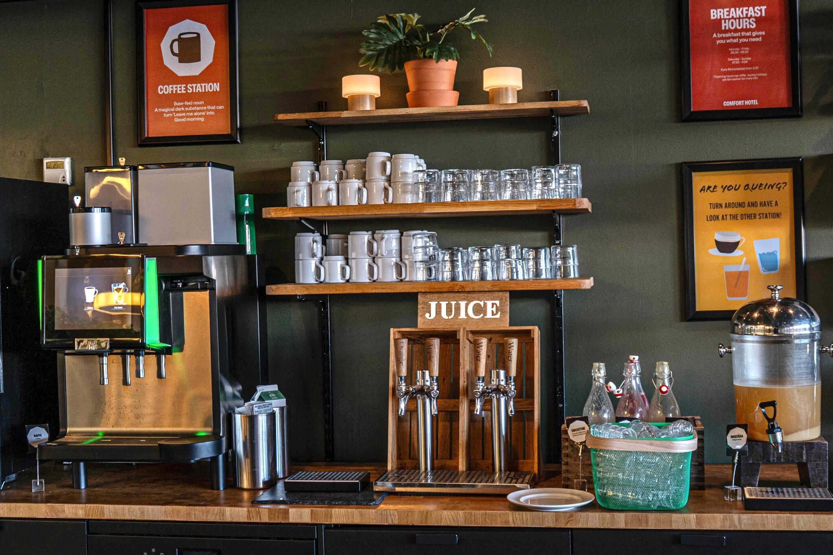 A coffee station with a coffee machine, mugs, and juice dispensers.