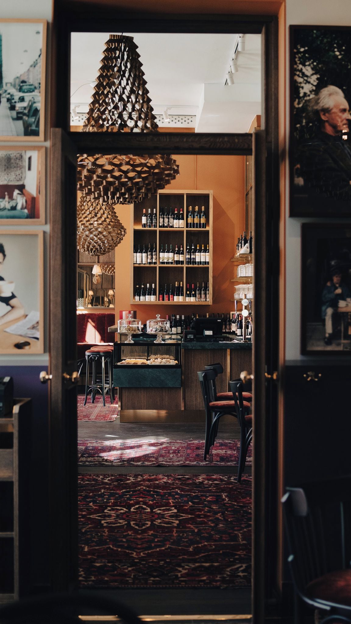 A bar area with a wine rack, bar counter, and seating.