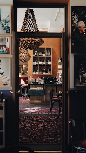 A bar area with a wine rack, bar counter, and seating.