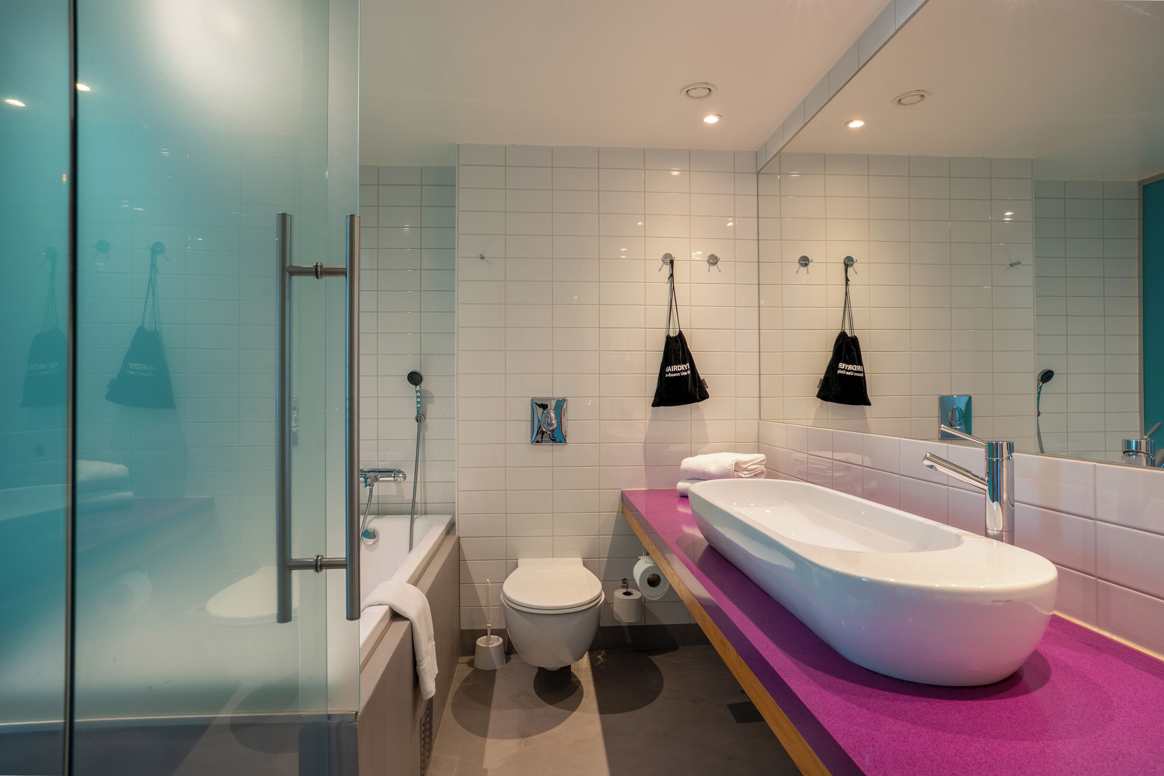 superior king room | bathroom | rainfall showerhead, eco-friendly toiletries, hair dryer, towels