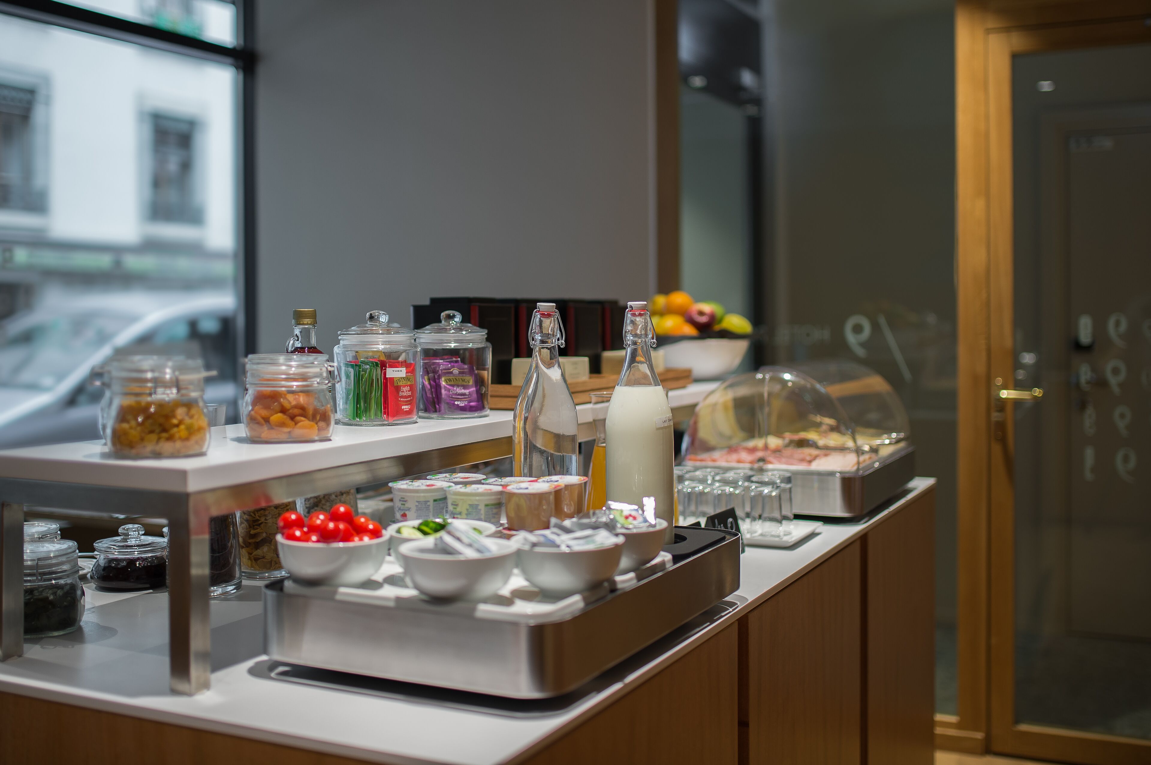 A buffet setup with various food items and condiments.