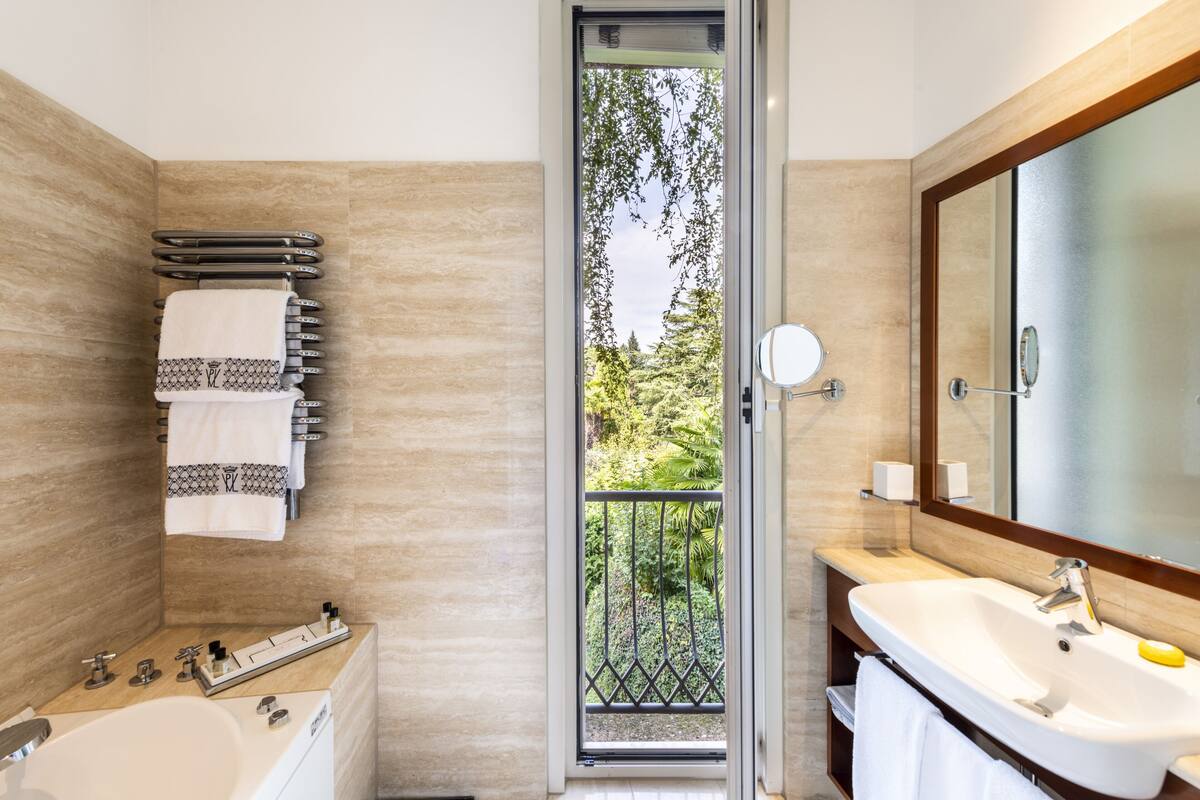 designer toiletries, hair dryer, bathrobes, slippers