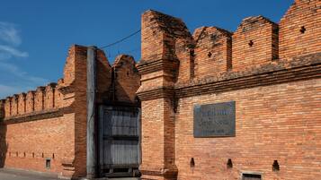 A brick wall with a large metal gate and a sign that reads "TAPHA Gate".