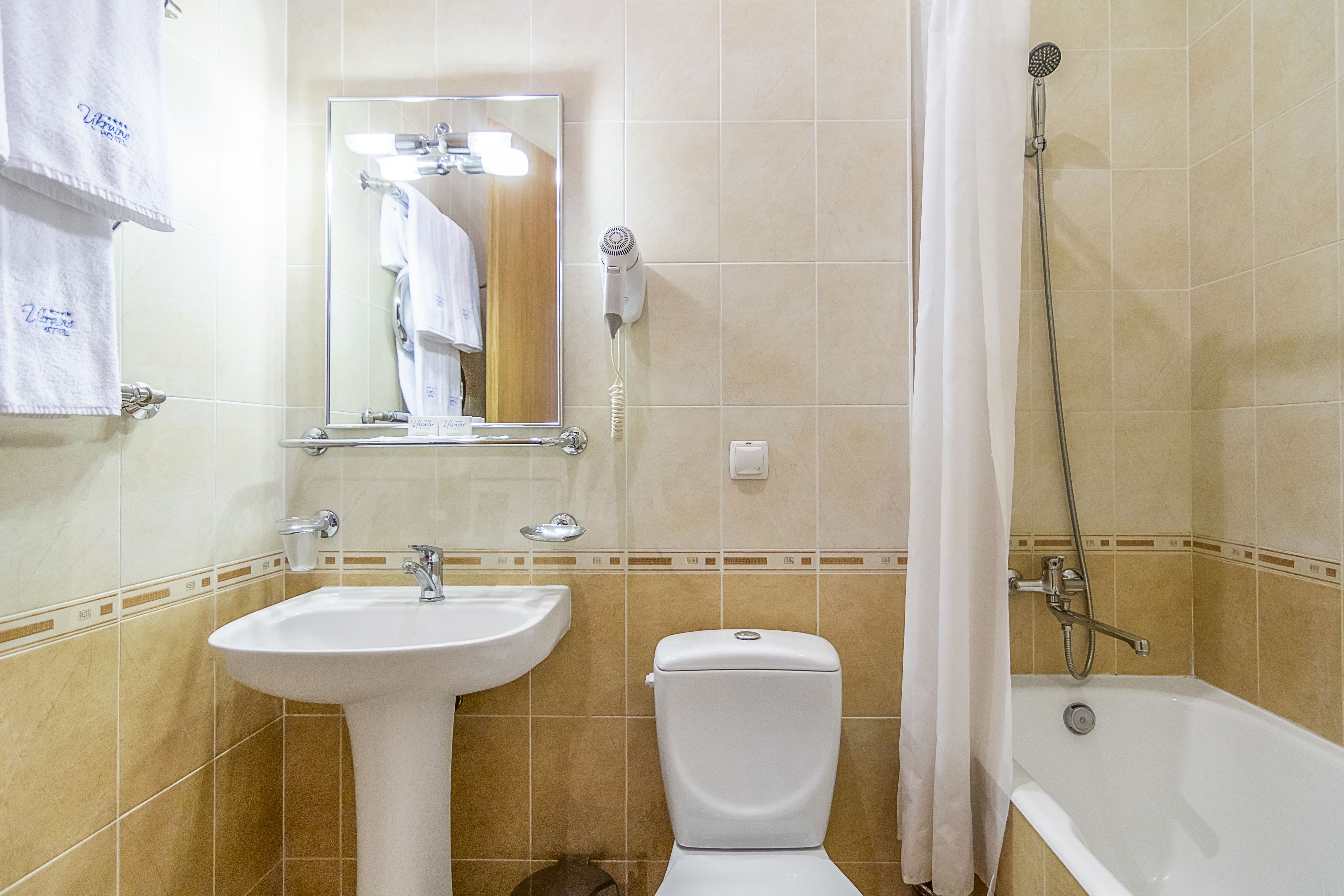 A bathroom with a sink, toilet, and shower.