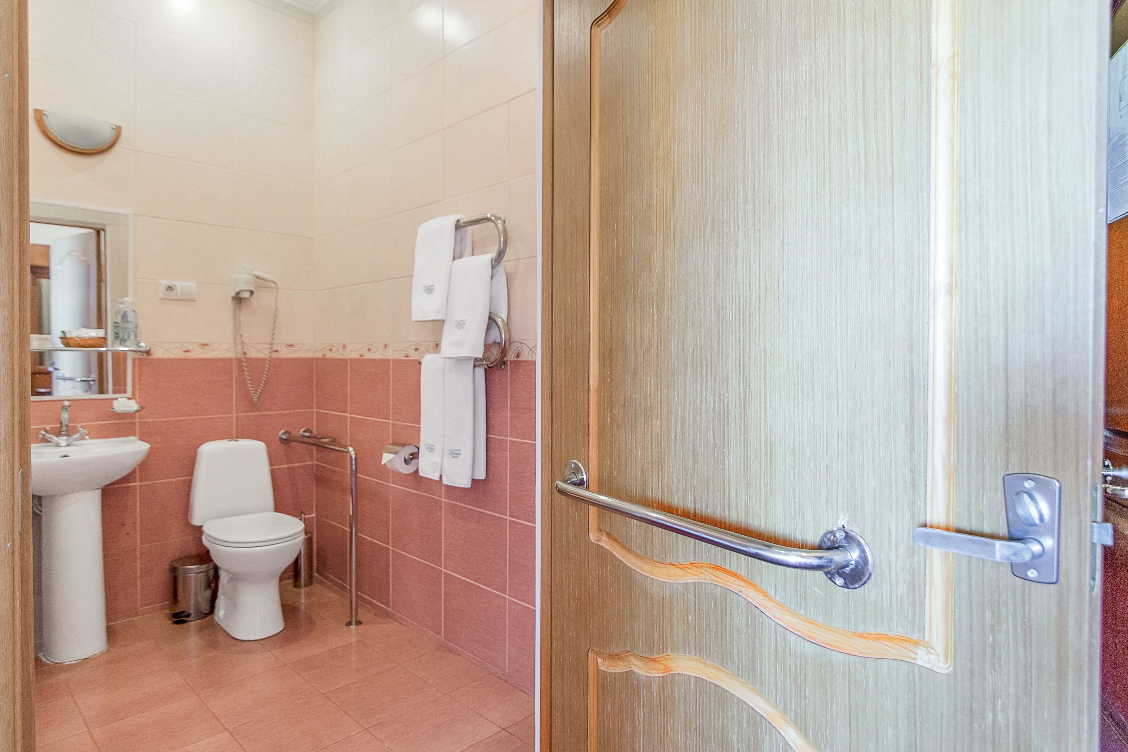 A bathroom with a sink, toilet, and shower.