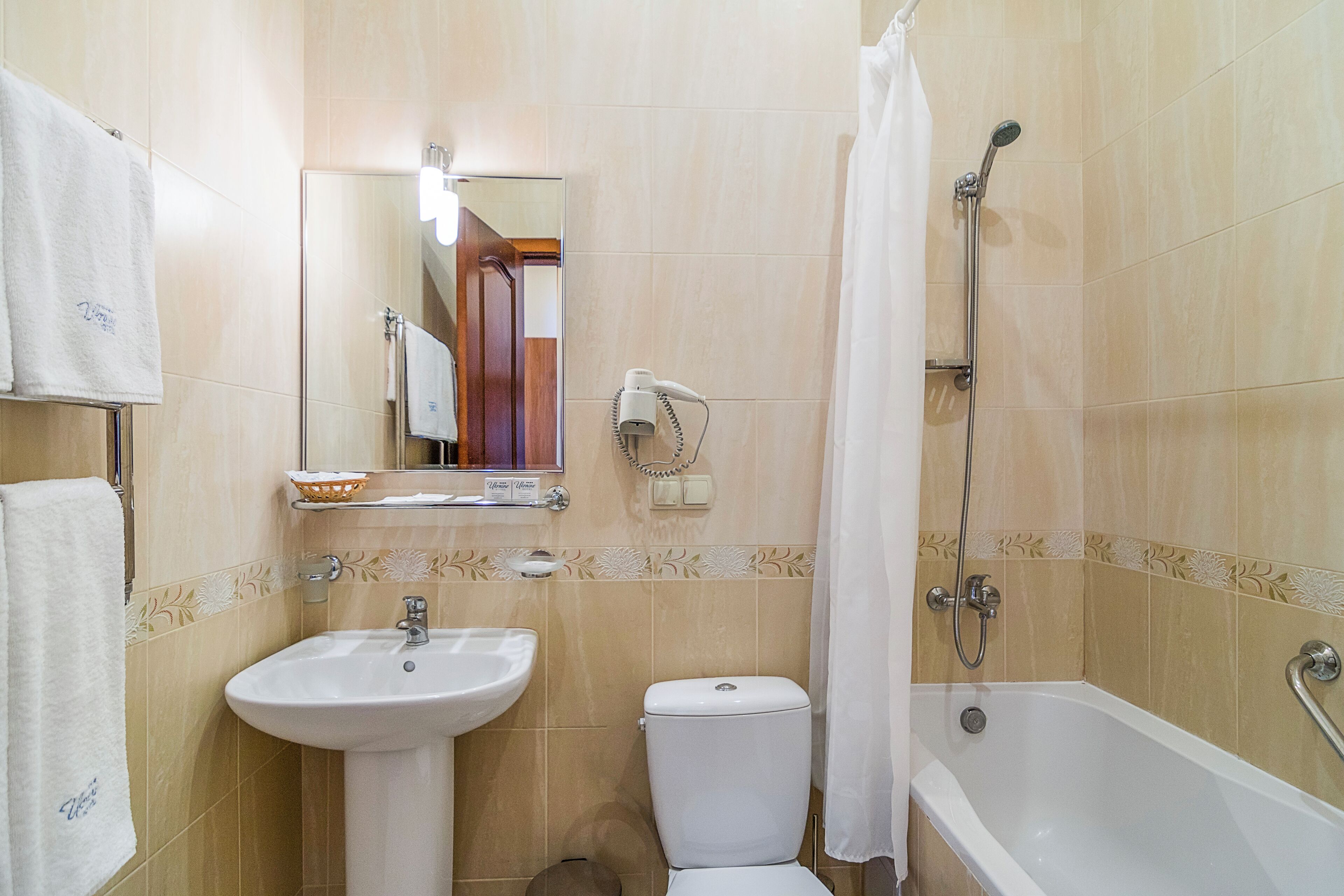 A bathroom with a sink, toilet, and bathtub.