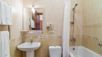 A bathroom with a sink, toilet, and bathtub.