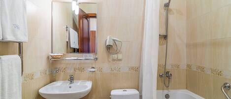 A bathroom with a sink, toilet, and bathtub.
