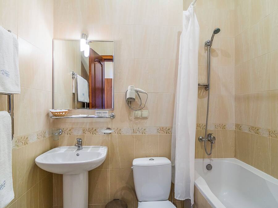 A bathroom with a sink, toilet, and bathtub.