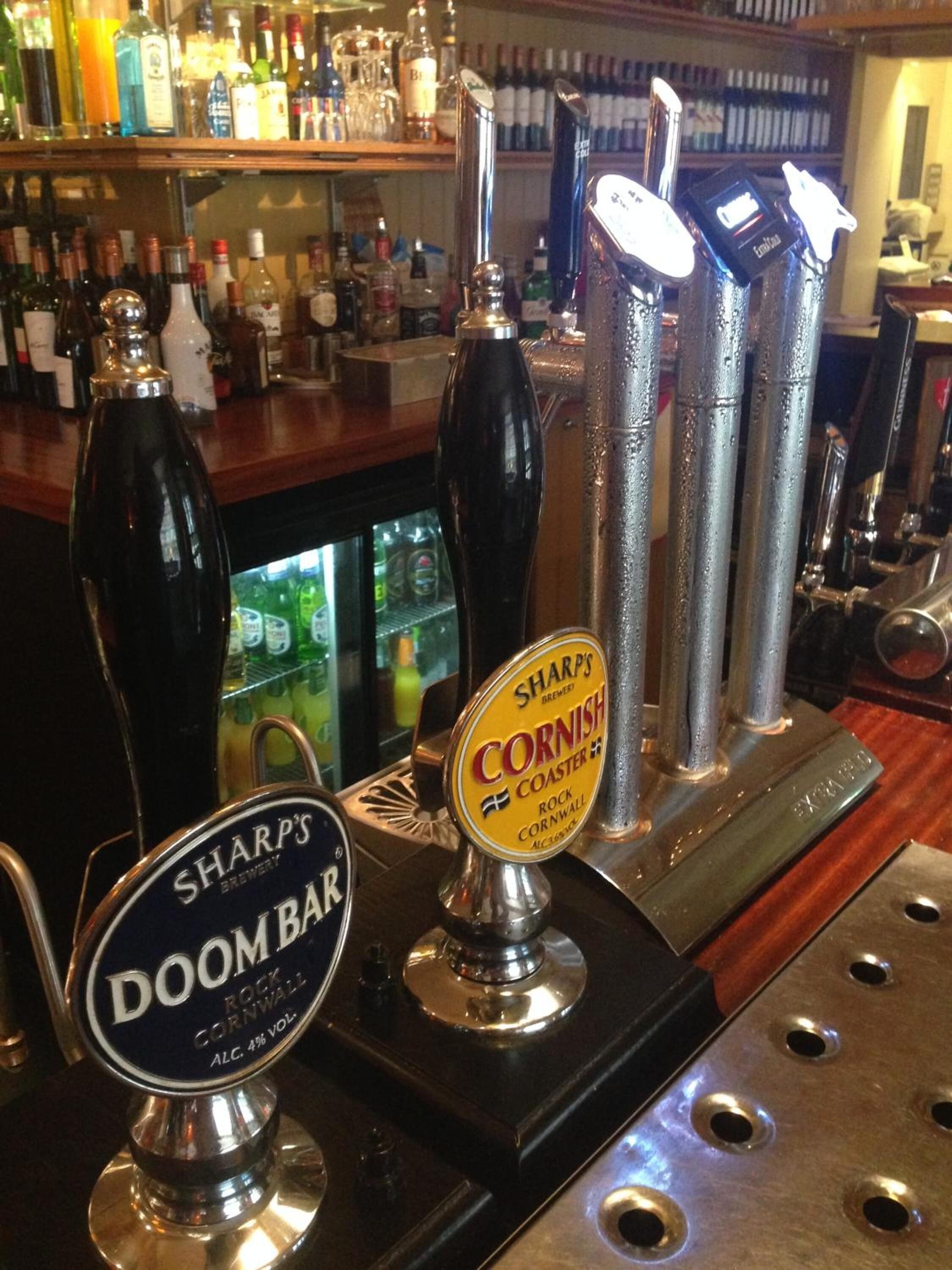 A bar with multiple taps, including 'SHARP'S DOOM BAR' and 'SHARP'S CORNISH COASTER'.
