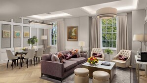 Una sala de estar moderna con un sofá, sillones, una mesa de centro y un comedor con sillas y una mesa.