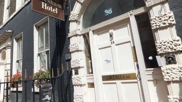 A hotel entrance with a sign reading "Gresham Hotel" and a door labeled "GRESHAM." - Gresham Hotel Bloomsbury (London)