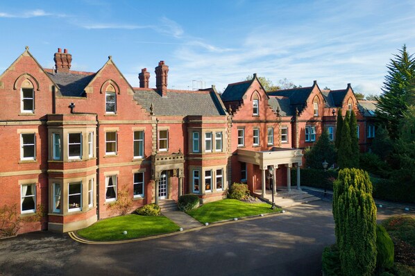A large, red-brick building with multiple windows and a central entrance.