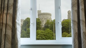 A view of a castle through a window with curtains. - Sir Christopher Wren Hotel (Windsor)