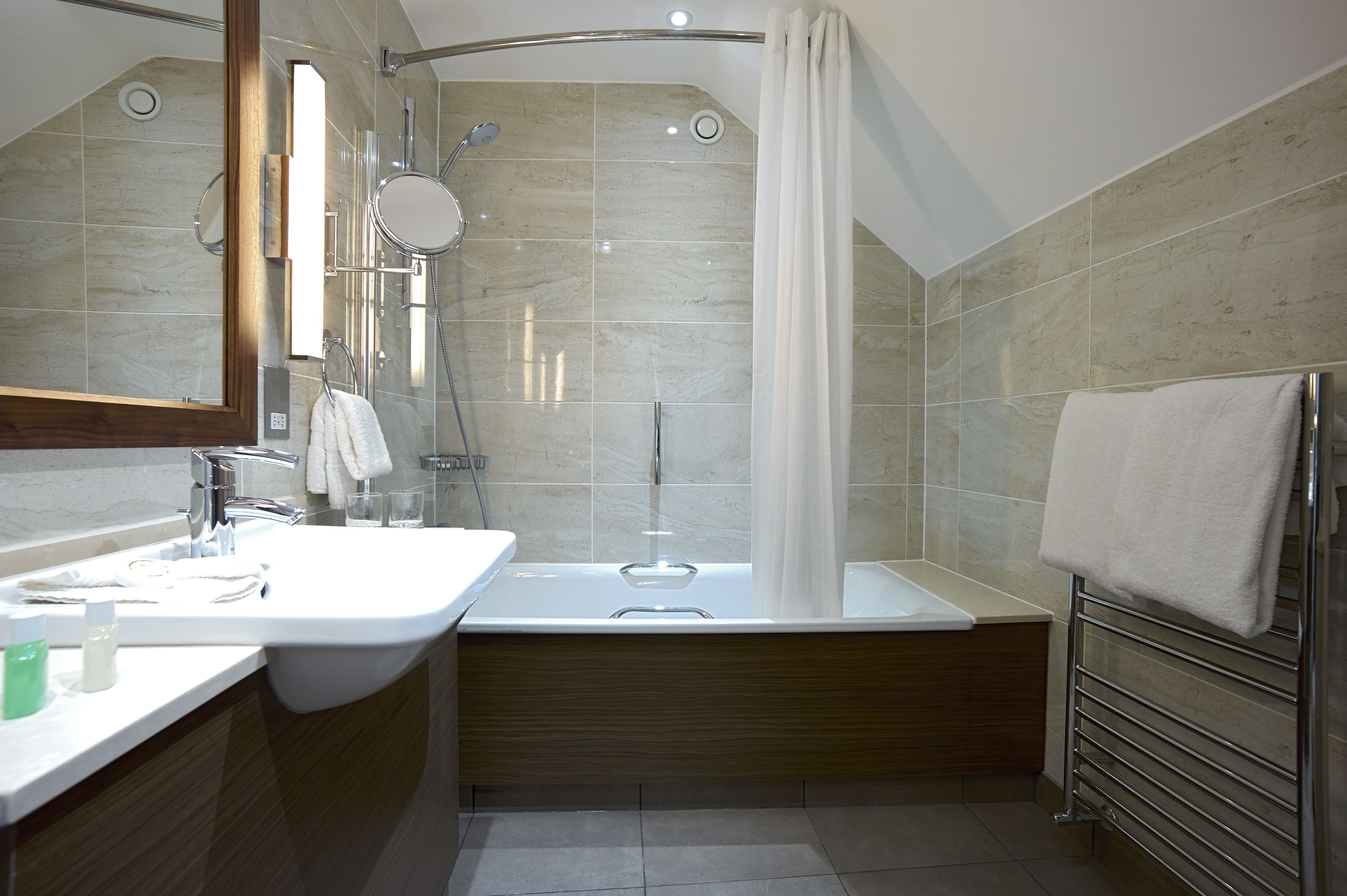 combined shower/bathtub, designer toiletries, hair dryer, towels