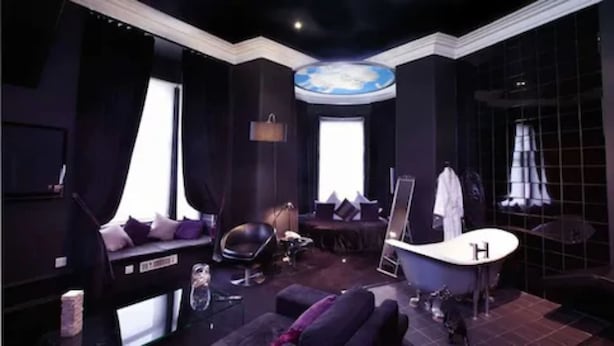 A luxurious room with a large bathtub, a sofa, and a vanity area. - Carmelite Hotel (Aberdeen)