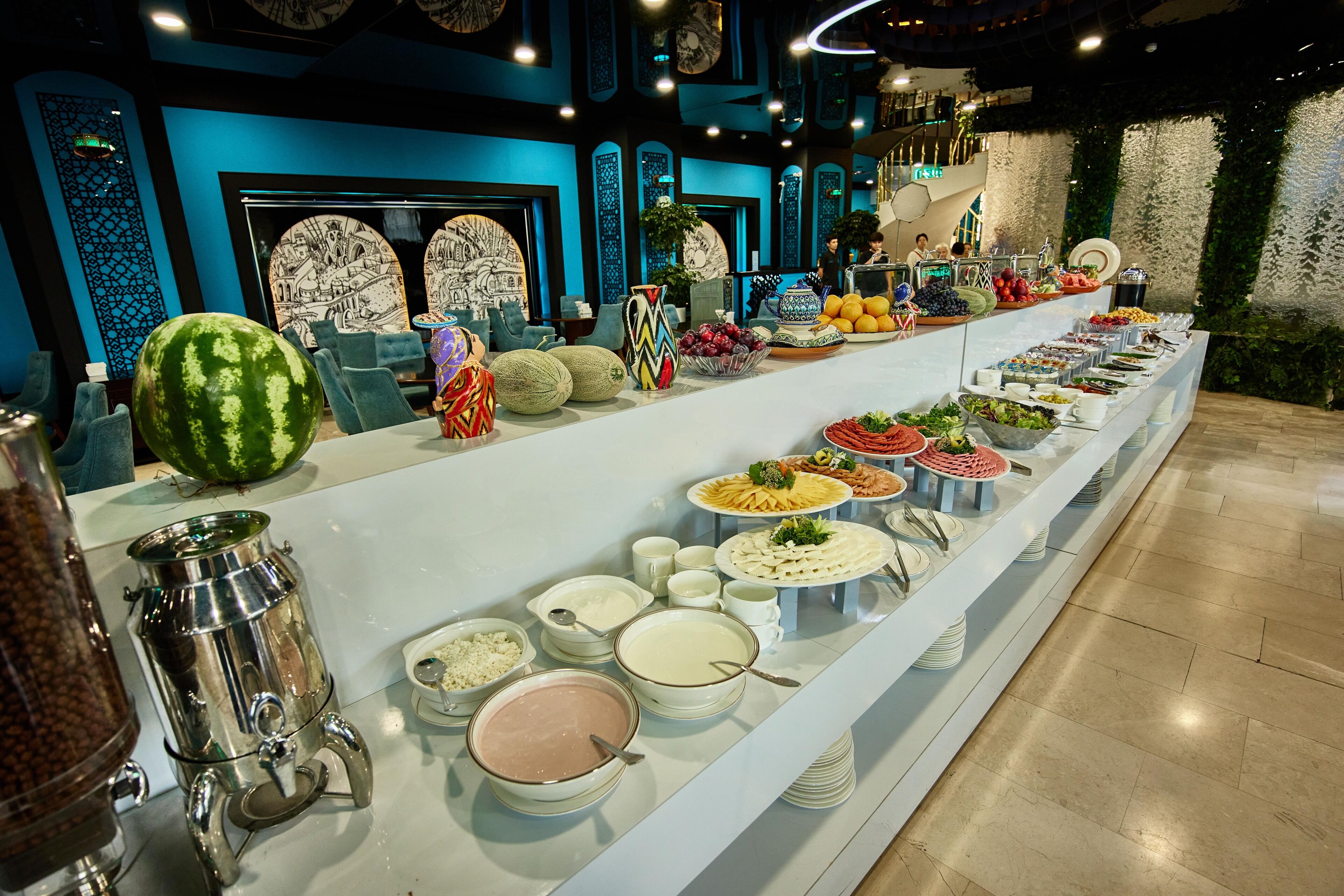 A buffet with various food items and a coffee station.