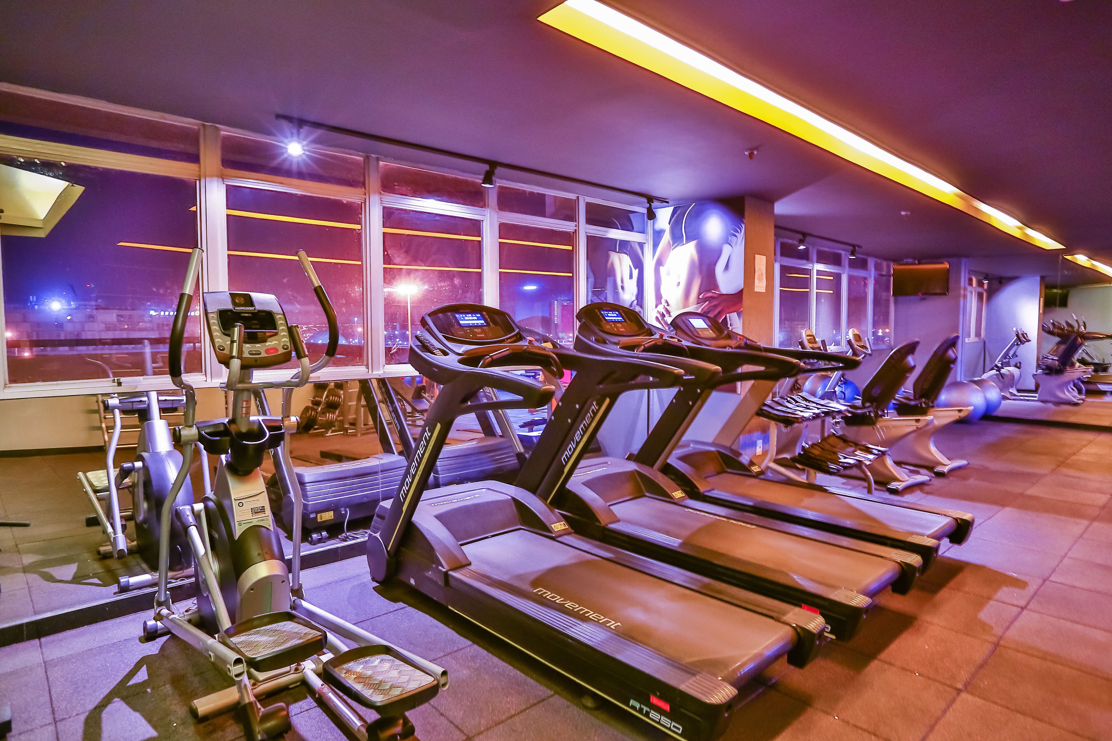 A gym with treadmills, ellipticals, and other fitness equipment.