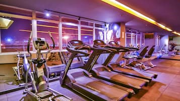 A gym with treadmills, ellipticals, and other fitness equipment.