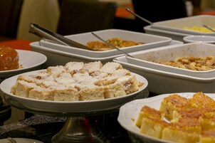 A buffet with various dishes including a cake and a casserole.