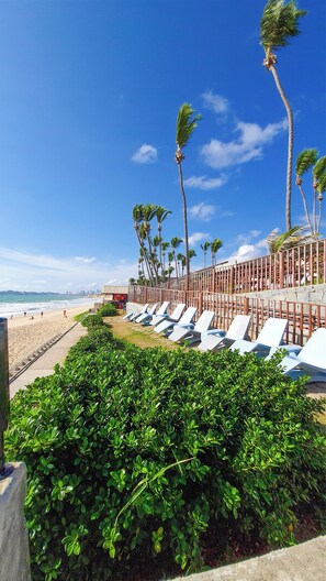 On the beach, white sand, beach towels, beach volleyball