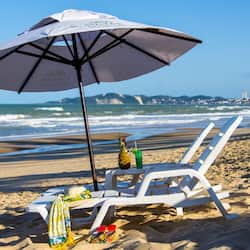 On the beach, white sand, beach towels, beach volleyball