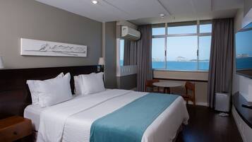 Deluxe Room, Beach View | Pillow-top beds, minibar, in-room safe, individually decorated