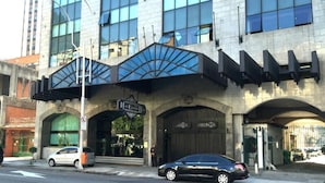 A hotel with a modern facade, large windows, and a prominent entrance with a metal canopy. - Hotel Atlantico Star (Rio de Janeiro)