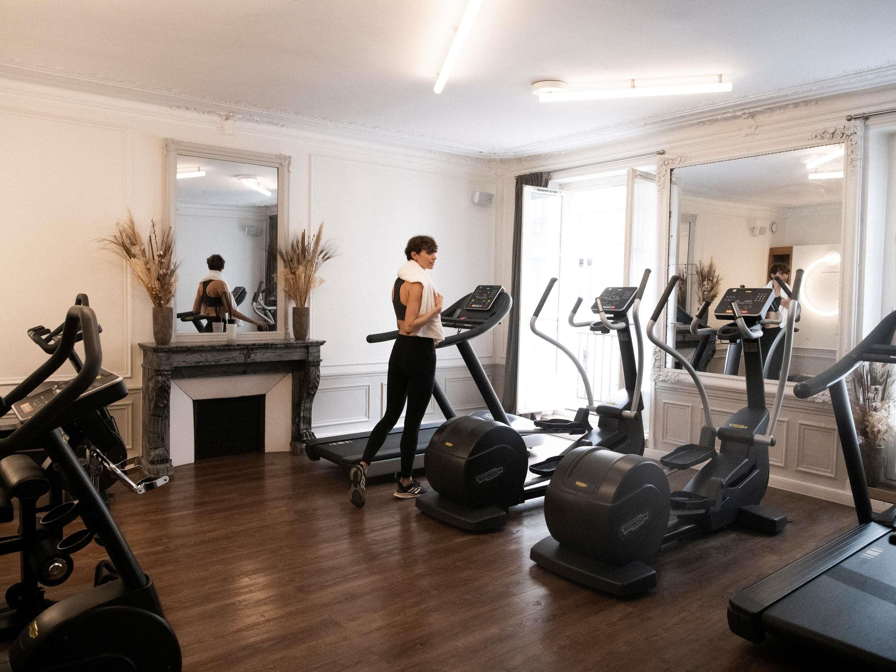 A gym with treadmills, a stationary bike, and a weight bench.