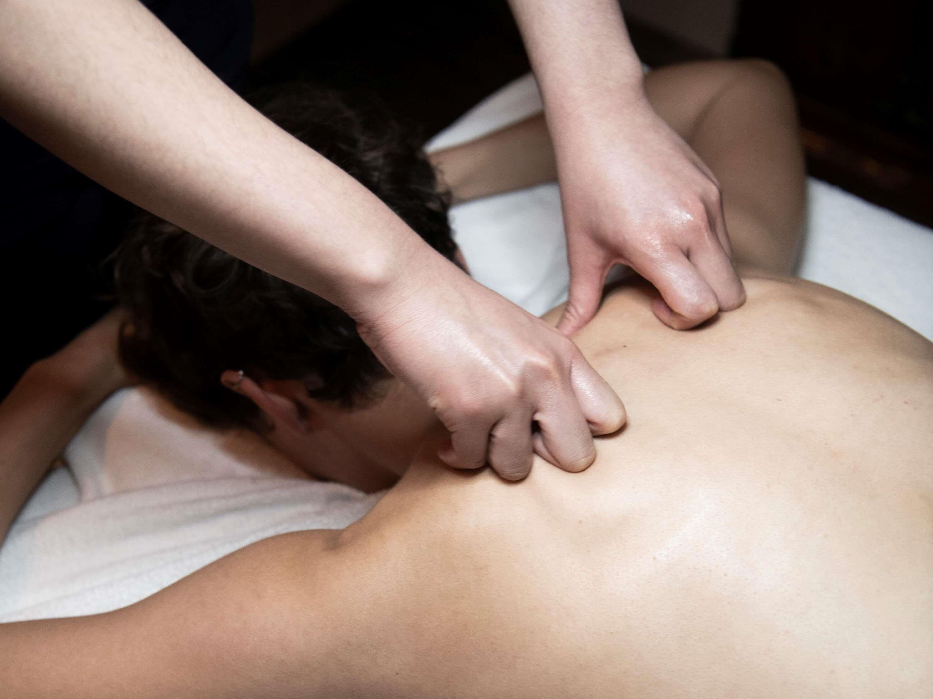 A person receiving a back massage.